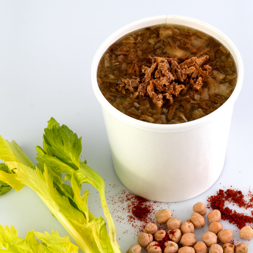 Soup container with celery and chickpeas lifestyle scene